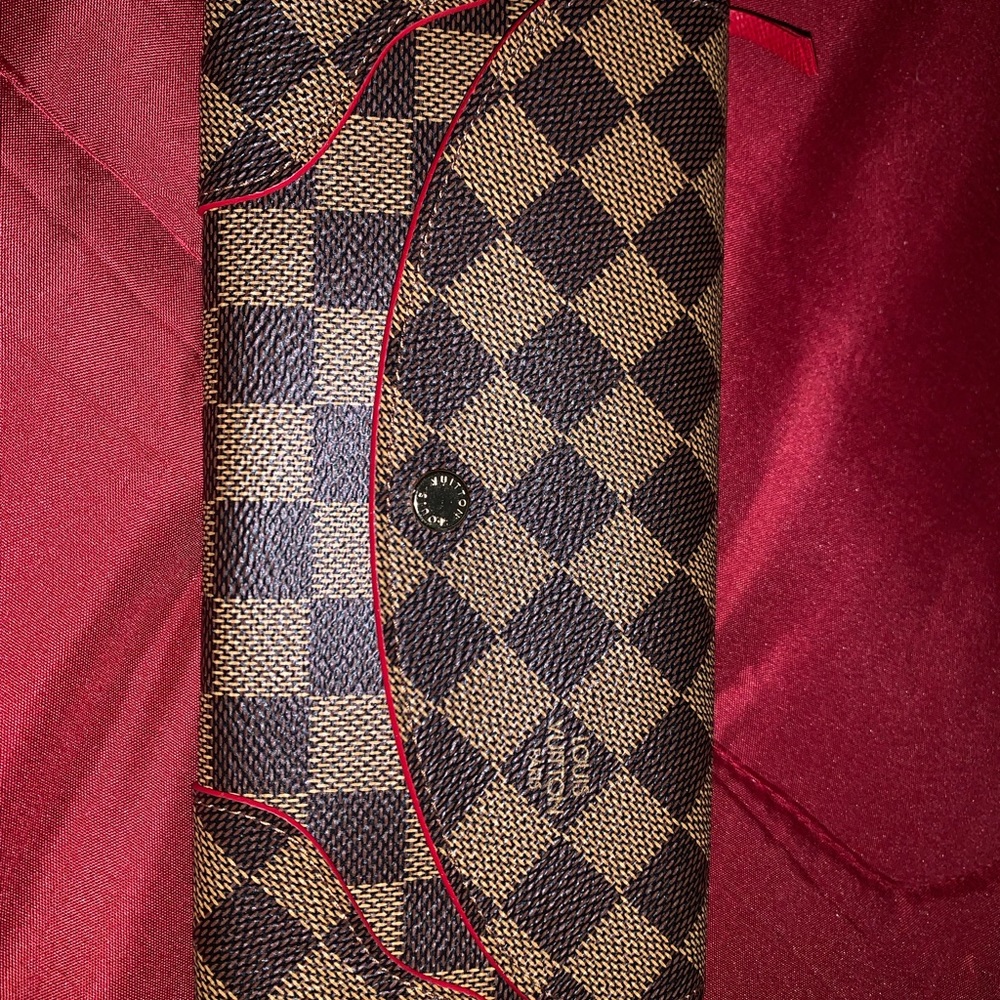 Louis Vuitton leather wallet with red trim